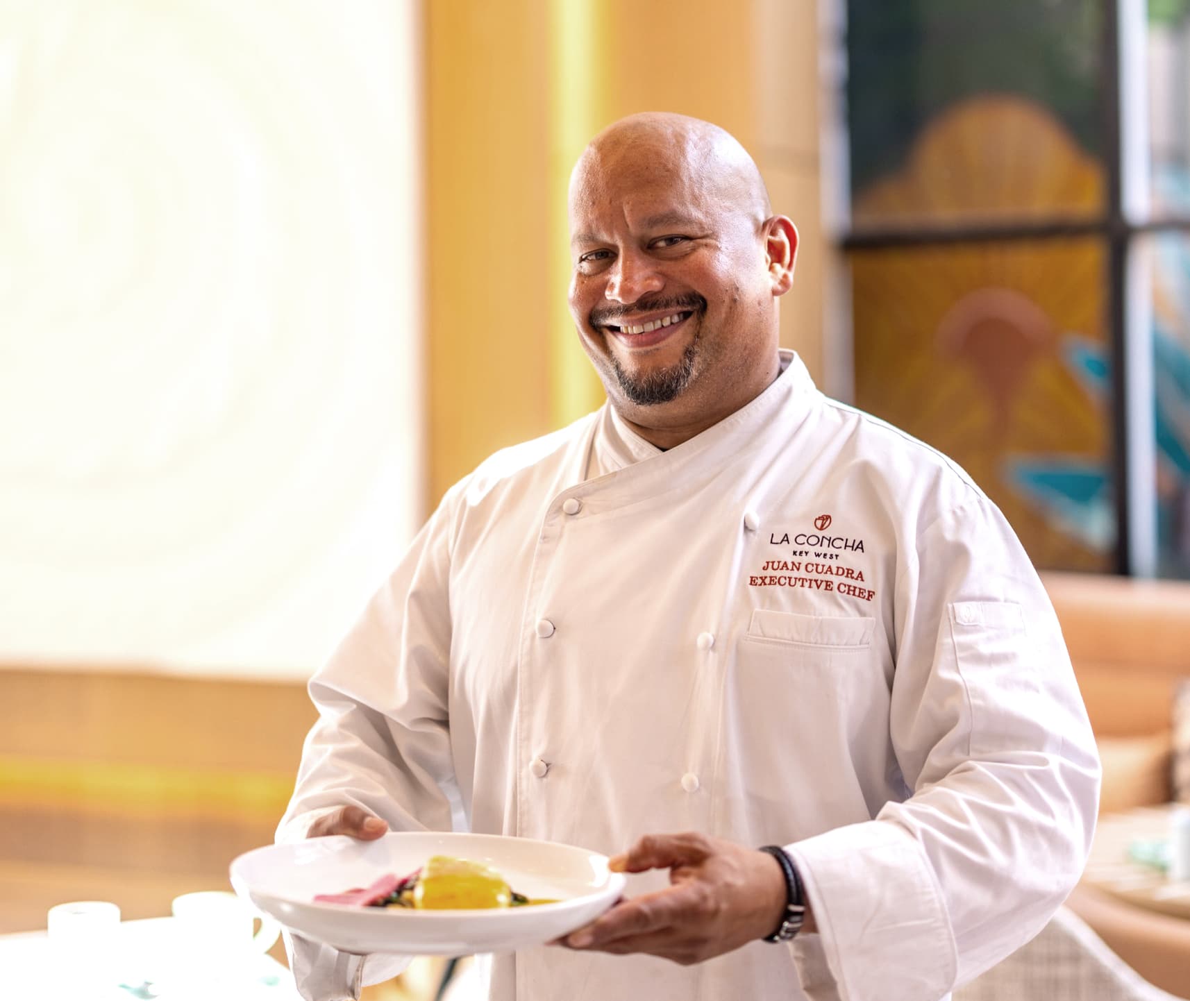 Chef Juan Cuadra holding a finished plate